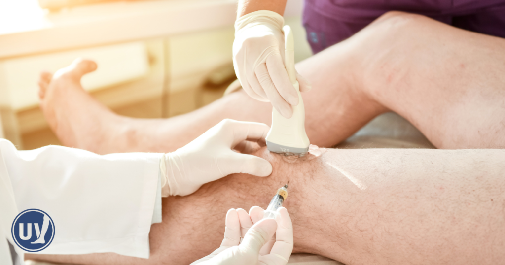 A vein and vascular specialist performing an ultrasound guided vein treatment