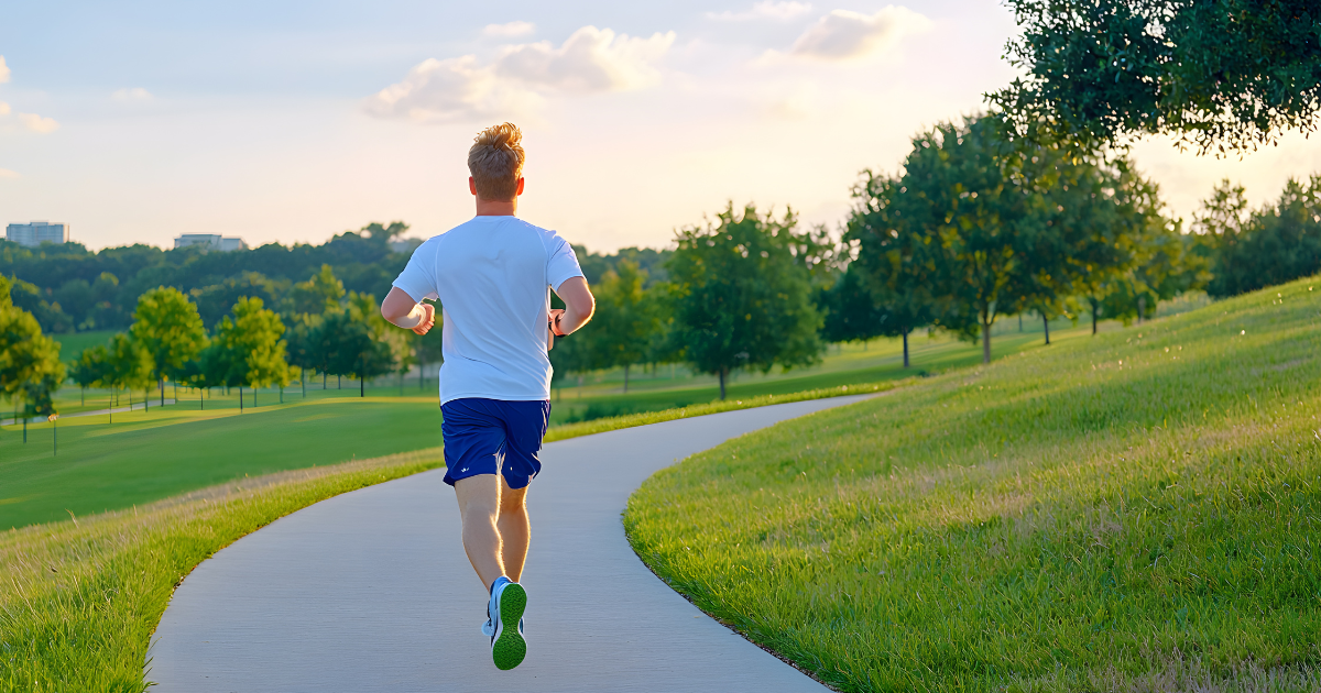 Runner jogging on a nature trail, illustrating the benefits of physical activity for vein and vascular health