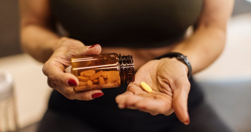 woman taking supplements to help improve blood flow