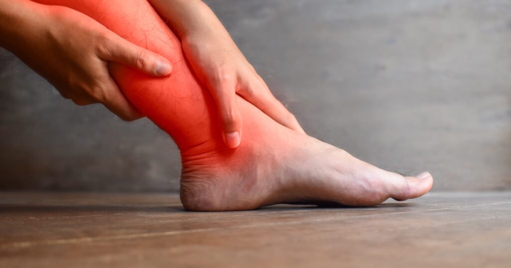 Image of woman holding her burning and aching leg