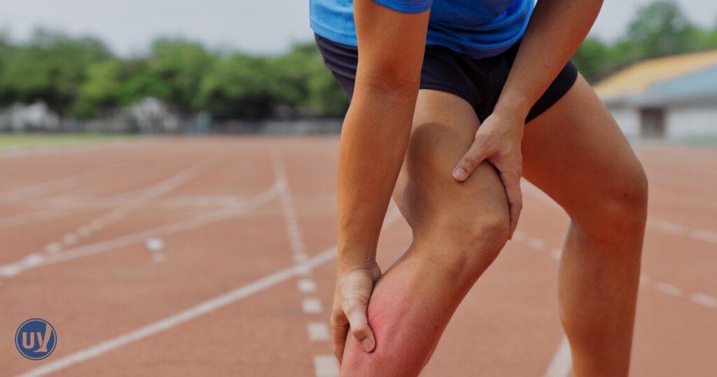 A man stopping to check his leg during his workout as he felt his leg burn and ache