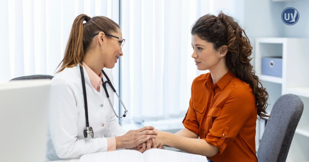 Vascular specialist discussing fibroid treatment options with patient.