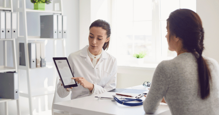 A vascular specialist is showing a patient the differences between arterial and venous diseases on an electronic device