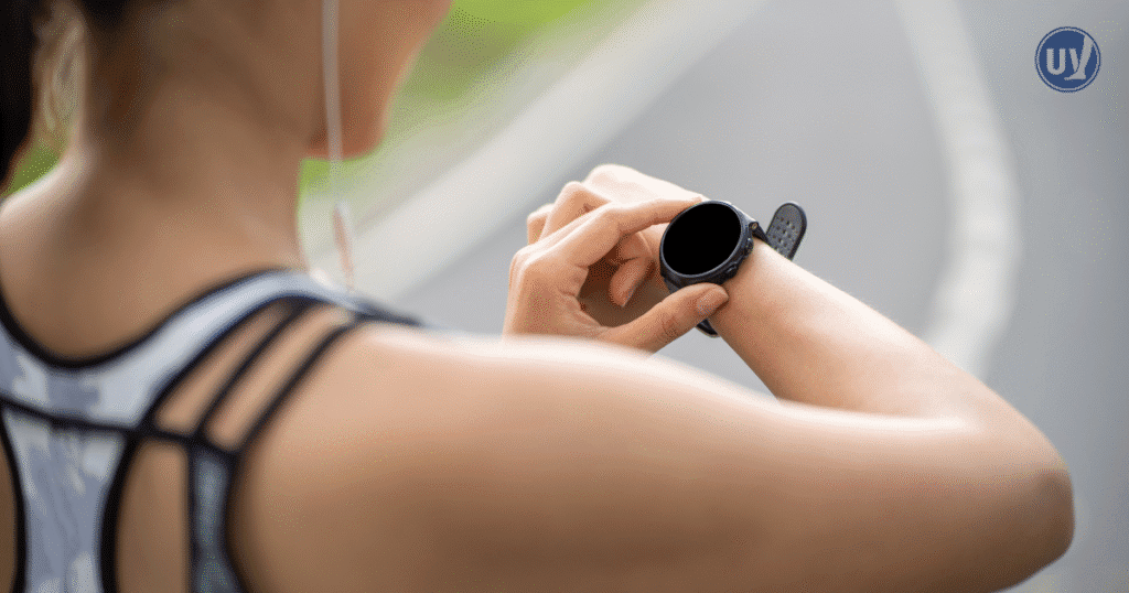 A person holding up their smartwatch to view their lifestyle app