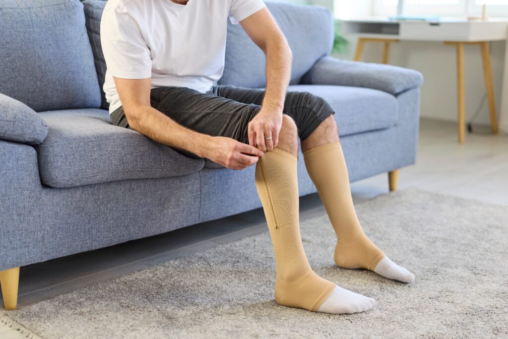 a person putting on compression socks due to varicose veins