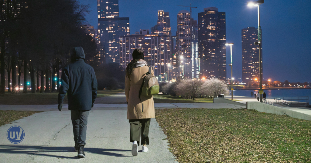 Woman walking through city streets at night, representing lifestyle factors that may contribute to hemorrhoid flare-ups