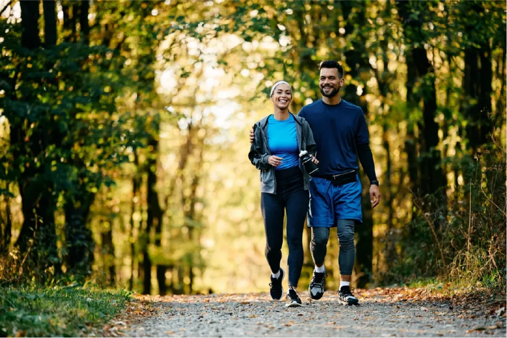 Couple walking in the park on National Walking Day for vein health