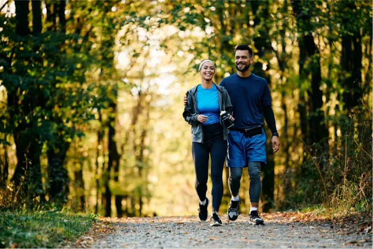 Couple walking in the park on National Walking Day for vein health