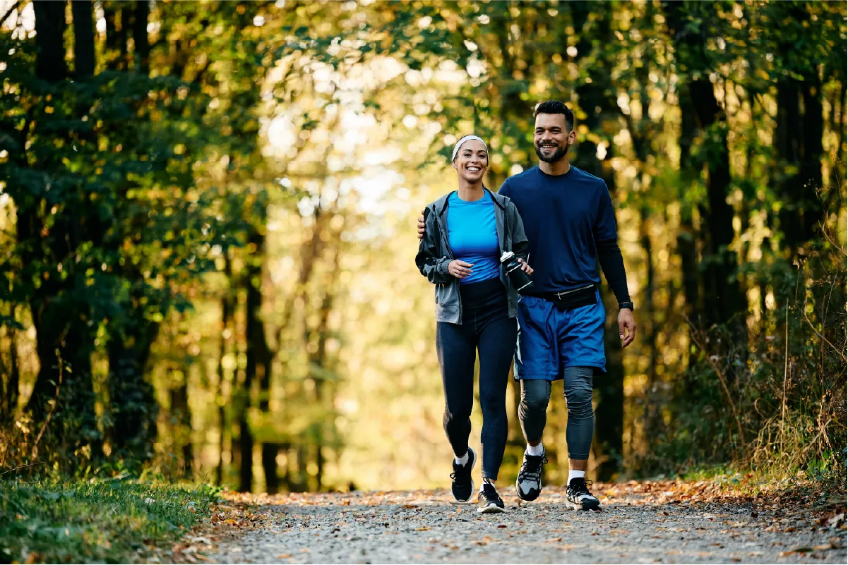Couple walking in the park on National Walking Day for vein health