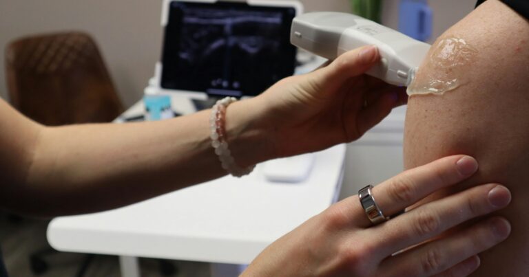 Vein specialist performing ultrasound on patient at vein consultation in Englewood