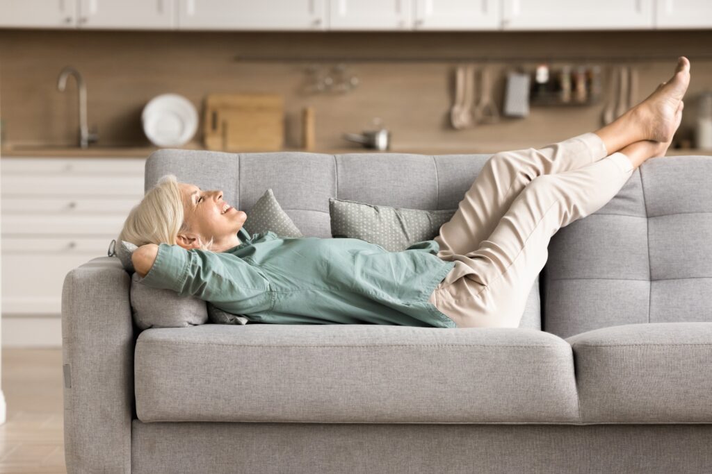 Woman lying on a couch with her legs elevated
