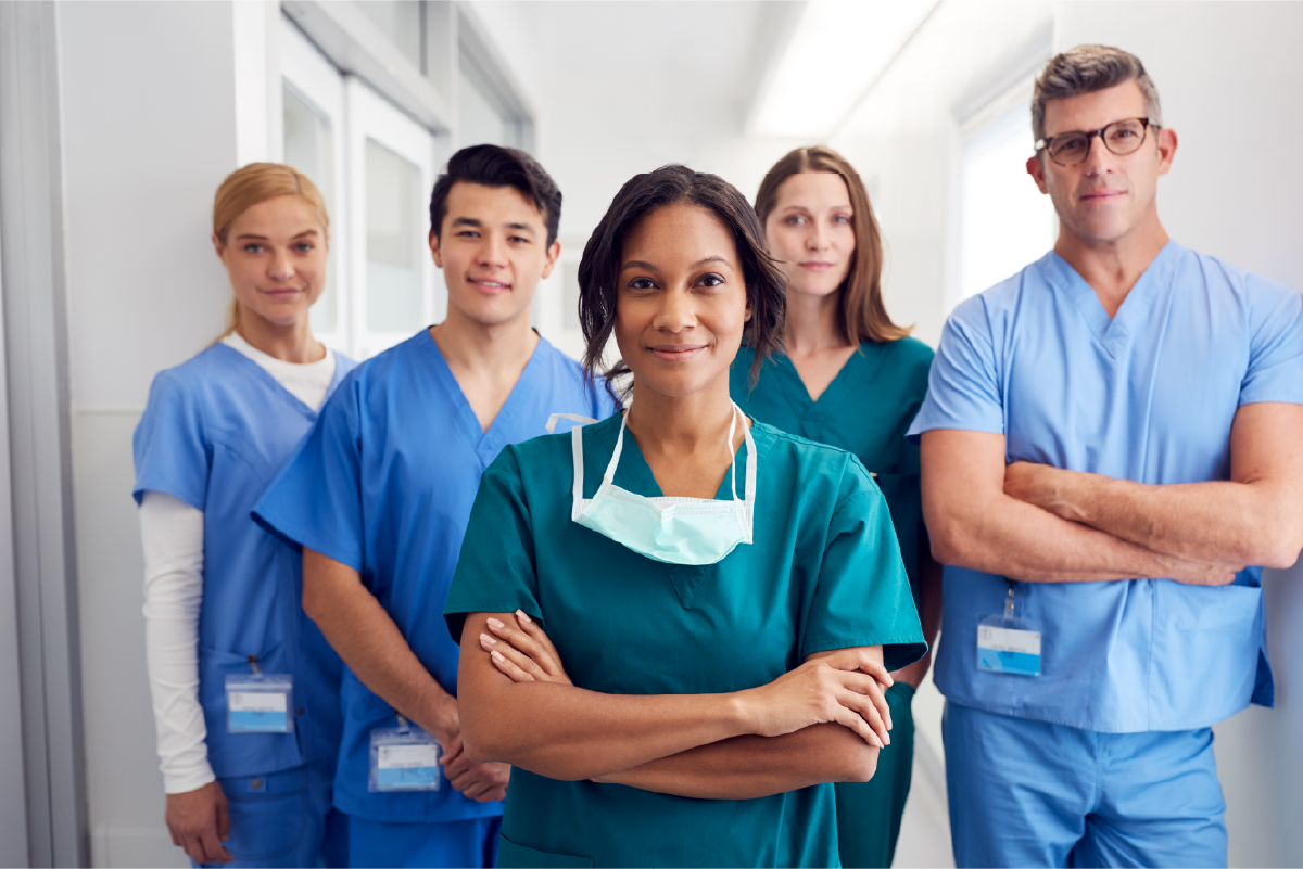 A group of nurses standing side by side smiling