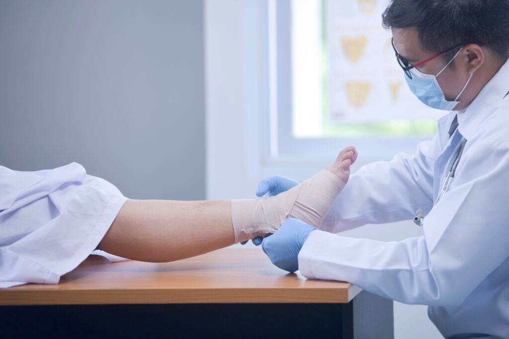 A vein specialist is checking on a patient's healing leg ulcer.