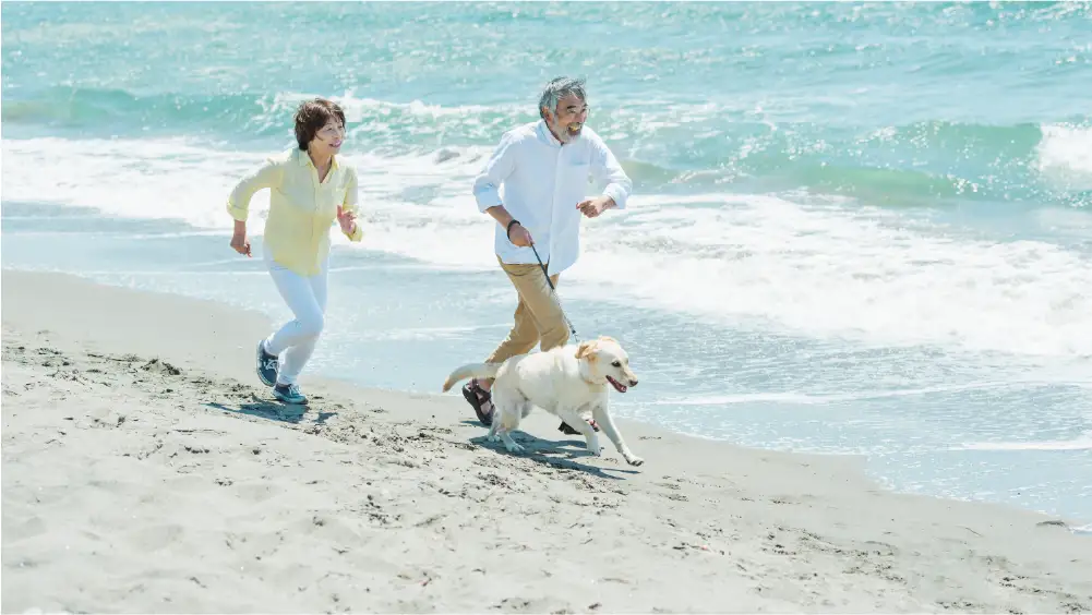 A senior man and woman running on the beach in Clearwater, FL