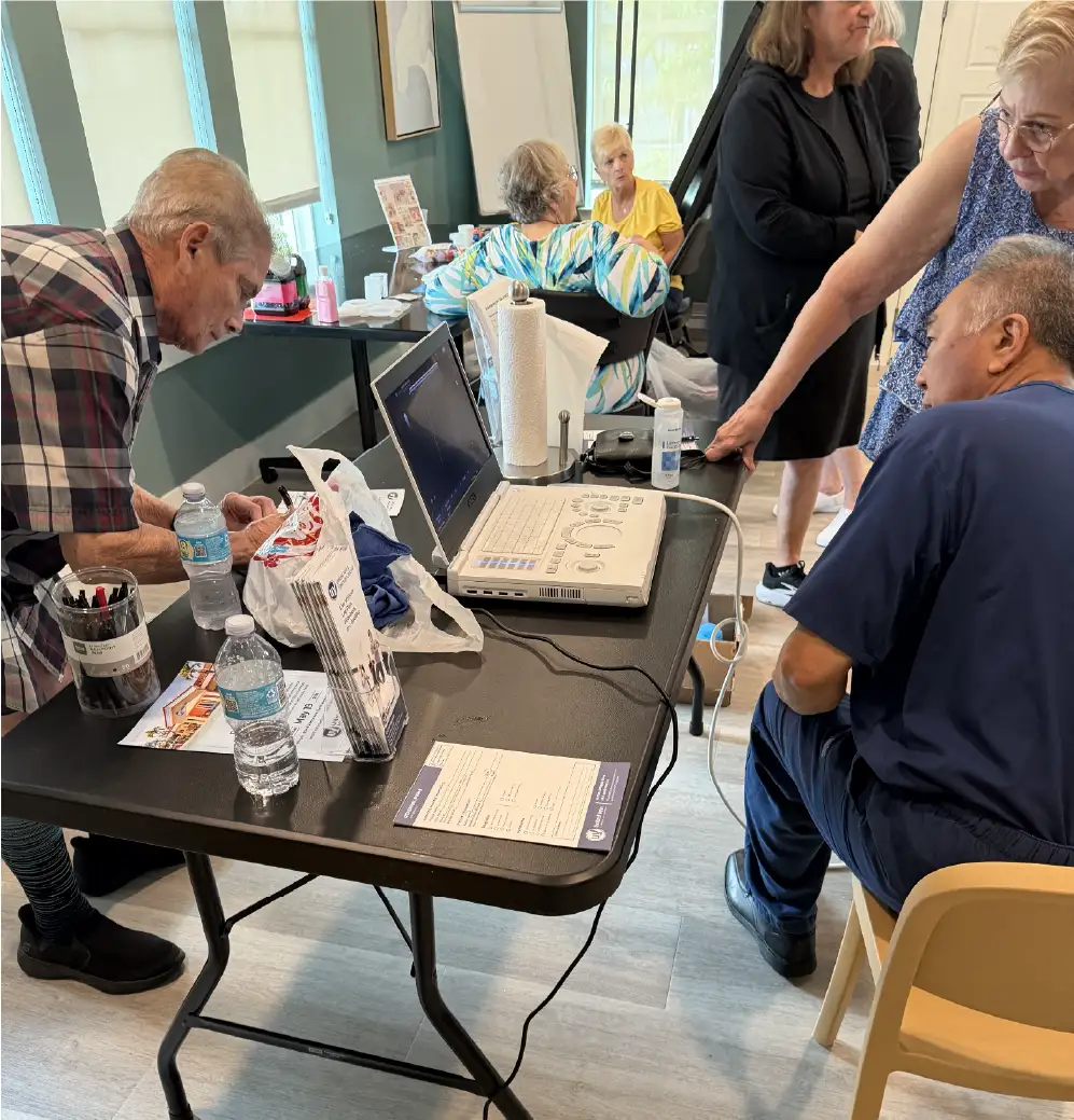 A group of senior citizens stopped at a United Vein & Vascular Centers booth during a health fair in Venice, FL