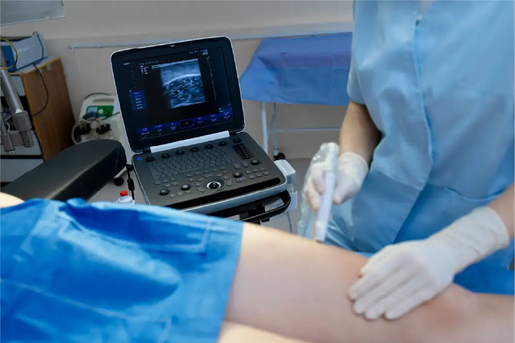 A vein specialist is shown performing a vein ultrasound on a patient's leg