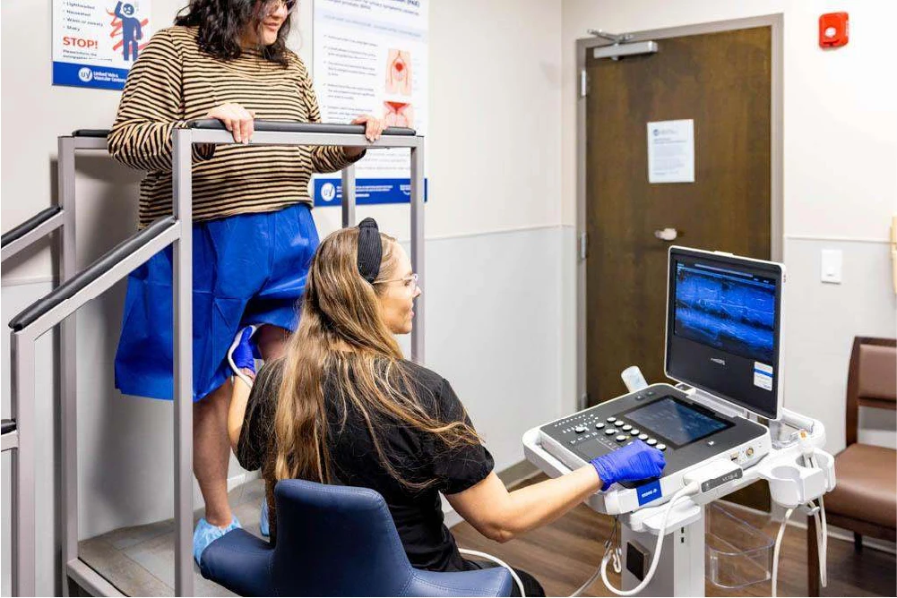 A vein specialist diagnosing the cause of visible veins