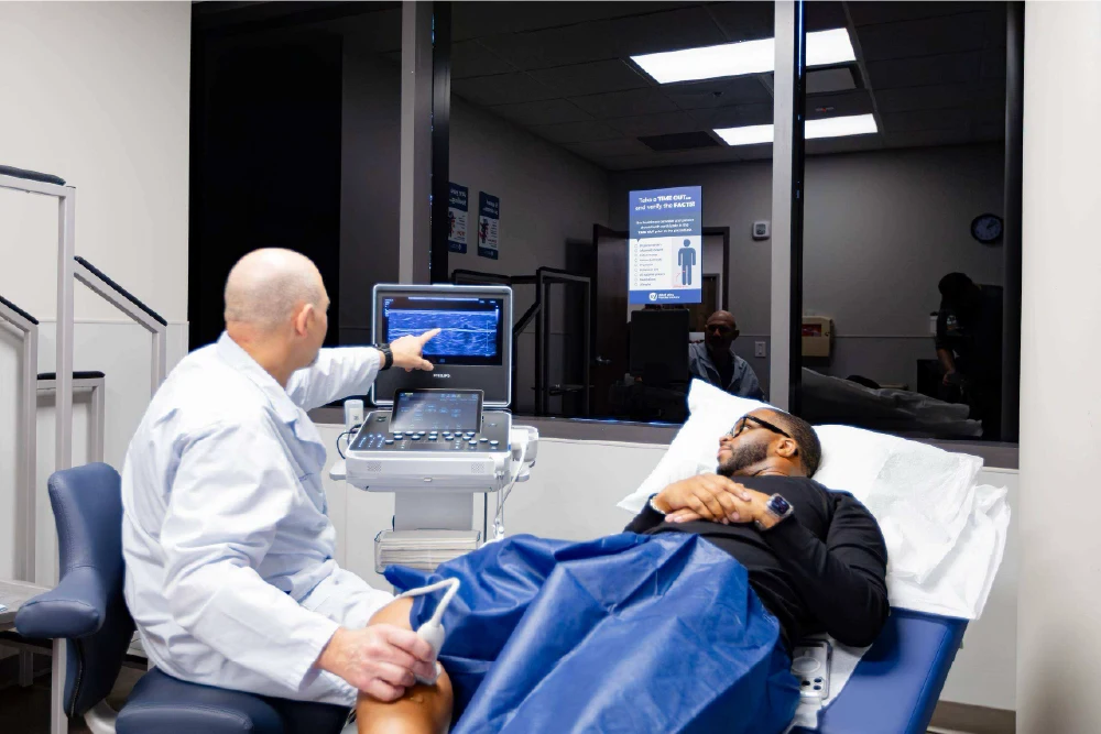 A vein specialist identifying a blood clot in a patient's leg during an ultrasound
